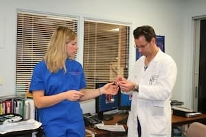 At Monongahela Valley Hospital, Dr. John Pacella learns about the newest tubes for performing radial catheterization from Stacey Anderson, a cardiovascular specialist from Cordis Corporation.