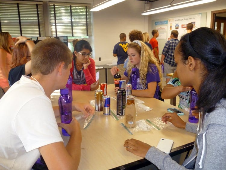Billy Waldron, HSTA mentor Akhila Kondai, Kiersten Dority and Abigail Samson compare sugar contents of various popular drinks at the Davis College of Agriculture, Natural Resources, and Design.