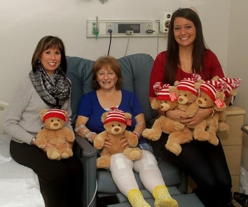 Monongahela Valley Hospital’s Orthopedic Institute Coordinator Lorraine Damich, RN, BSN, CPAN, (left) and donation coordinator Brittany Fagioletti, (right) deliver bears to the hospital’s Orthopedic Institute joint replacement patients. Barb Duranti, of Donora, is recovering from double-knee replacement surgery and said she was surprised with the Gund bear gift. It was one of 144 donated by Aéropostale stores in Washington, Greensburg and Pittsburgh.