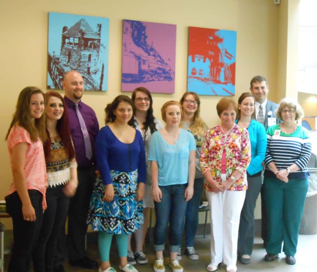 Altoona Area High School National Art Honor Society students and hospital officials unveiled new art located in an outpatient waiting area of UPMC Altoona’s area of Station Medical Center. Participants were (from left): Brooklyn Haugh, Madeline Quinn, students; Ron Bowser, art instructor; Orianna Green, Brandi Wilt, Kathryn Elder, Amber Gordon, students; Peggy Cawthern, president, Friends of UPMC Altoona; Laura Kozdra, art instructor; Mike Corso, executive director of Imaging, Cardiology & Radiation Oncology, and Sharon Wall, art instructor.