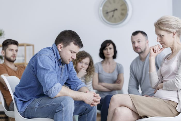 Man making confession during support group meeting