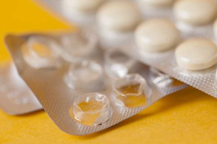 medicine concept. tablets on yellow. close up macro photo on yellow background
