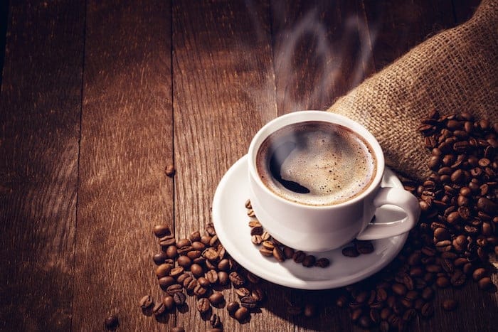 Cup coffee beans wooden dark background