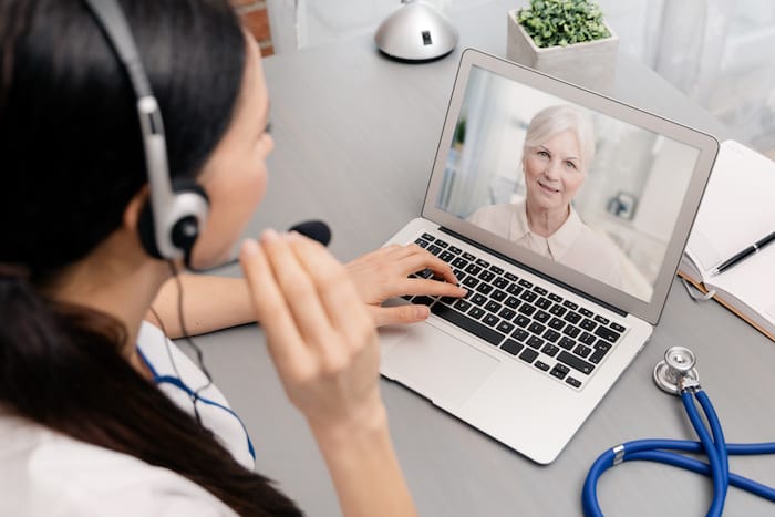 Doctor talking with a senior patient. Telemedicine concept