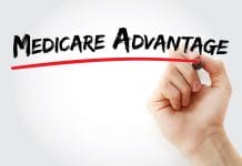 Hand writing Medicare Advantage with marker, concept background