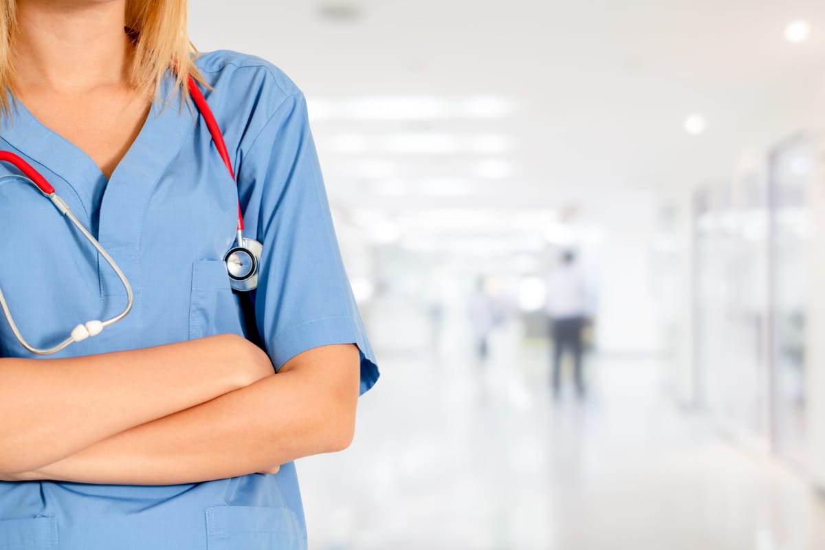 Nurse standing with her arms crossed in a hospital