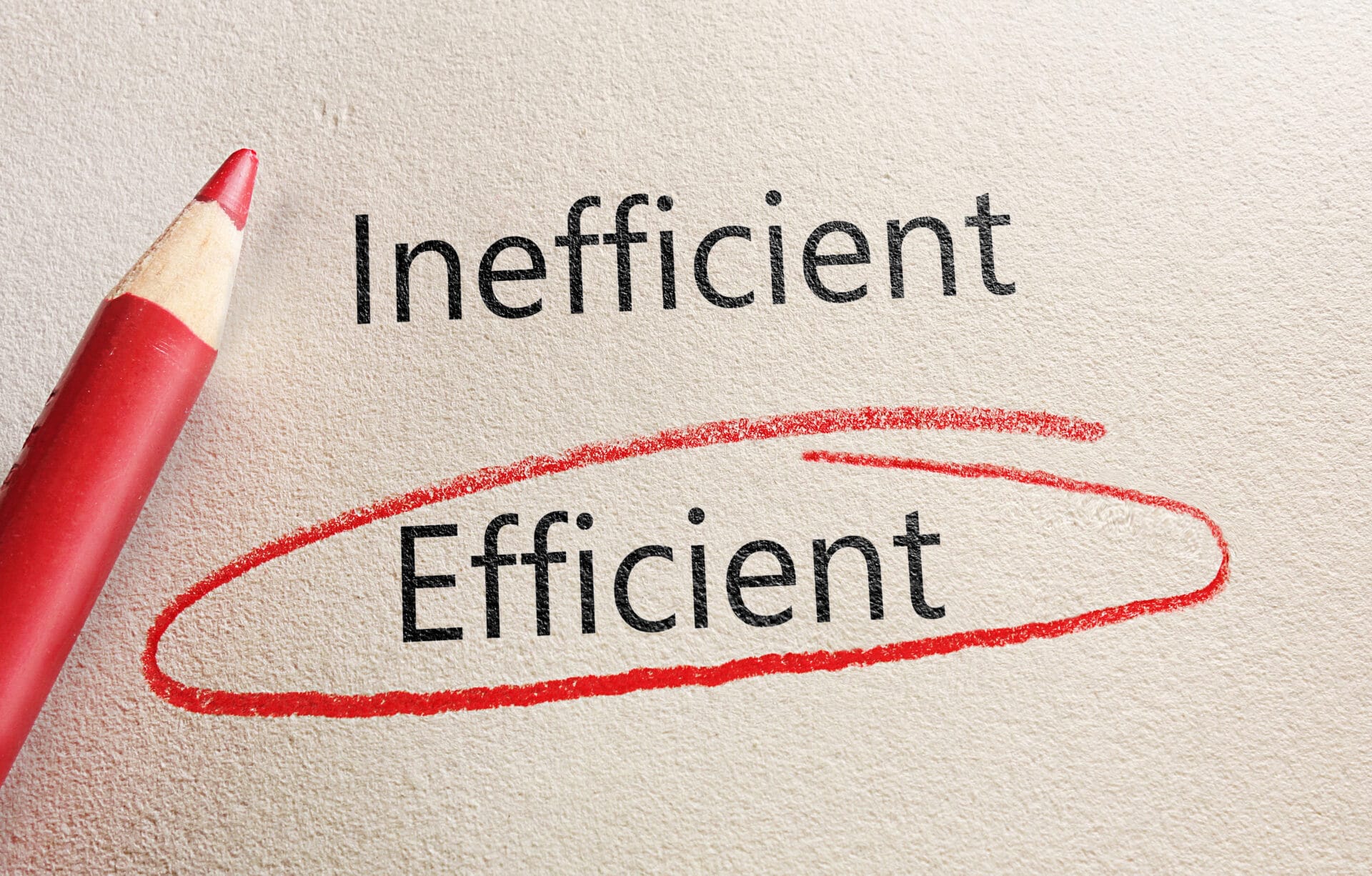 A piece of paper with the words “inefficient” and “efficient” printed on it—the latter is circled in a red marking.